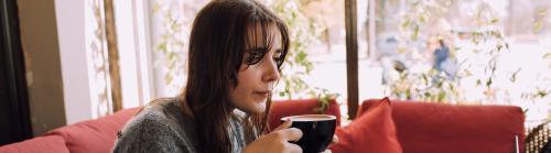 Woman engaging in a Zoom call with a coffee