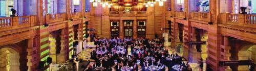 The Centre Hall at Kelvingrove Museum set out for a large event with purple and pink lights
