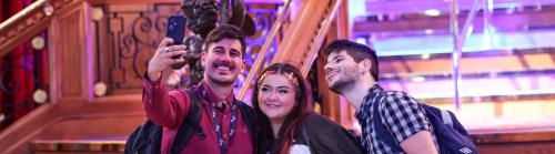 Three conference delegates taking a selfie at the Titanic Museum